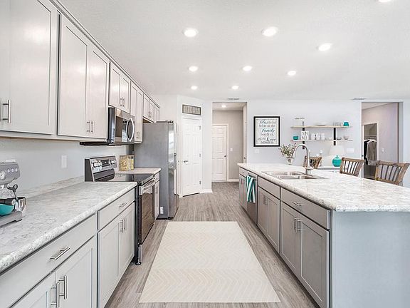 Your sunny, open kitchen features a counter-height island and a walk-in pantry - Westbrooke II home