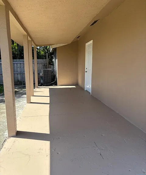 Large cover patio facing a large fenced-in yard