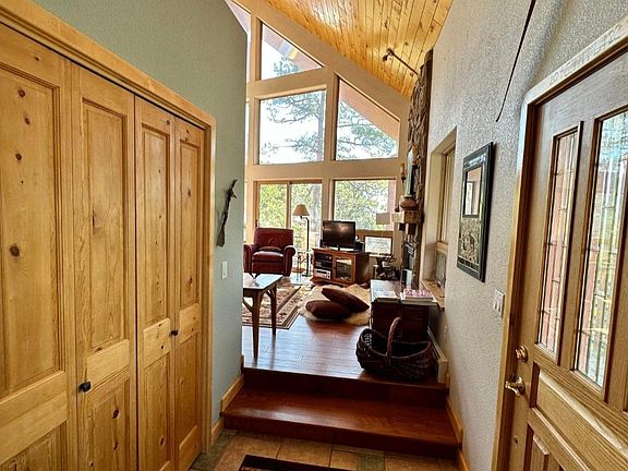 As you enter the front door you're WOW'd by the high ceilings, ambiance, and vast windows . Here you can shed your coat and shoes in a large warm interior closet knowing they will be warm when you put them back on.