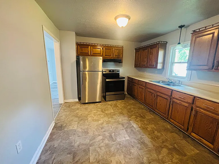 Kitchen with stainless steel and black appliances