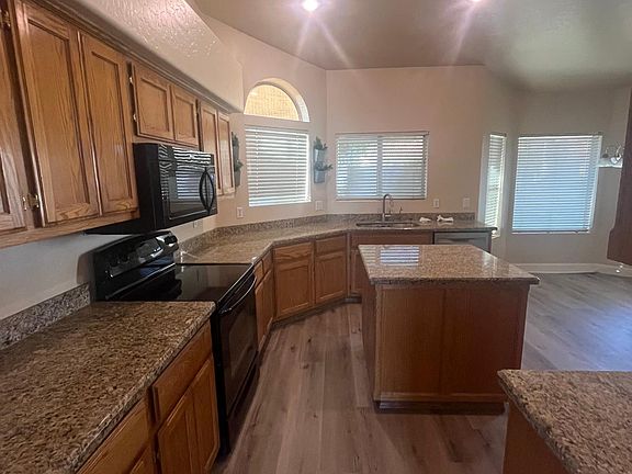 Kitchen - Granite Counter tops. Microwave & stove with island in the middle