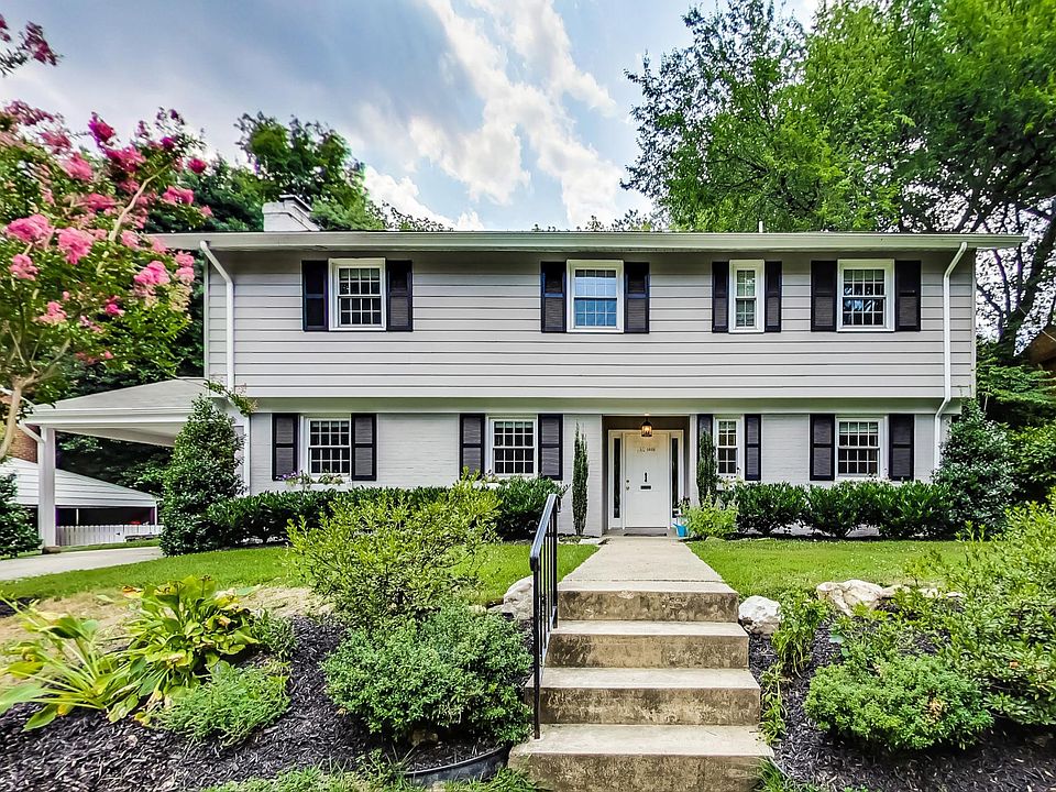 Welcoming traditional exterior with carport and driveway for off-street parking