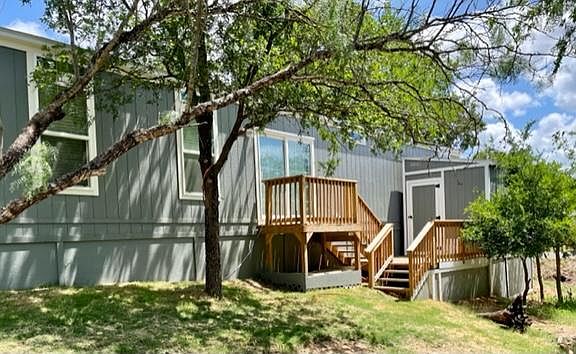 Back of property, outside deck & storage