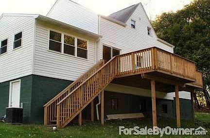 Front of house with paved parking
						:
						Everstone porch, new stamped concrete sidewalks, new gutters and downspouts