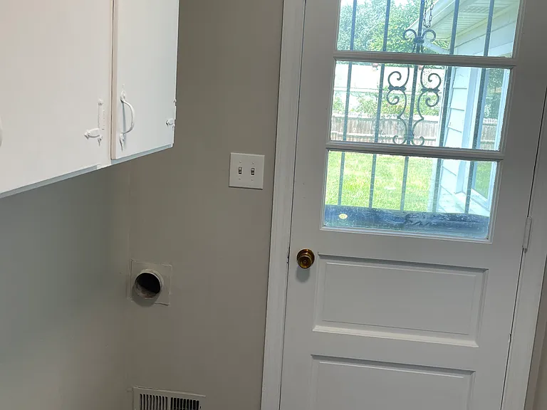 Utility room leads out to the back yard.