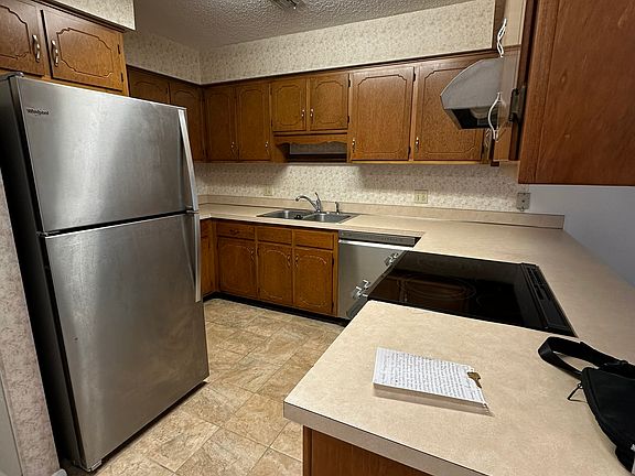 Large kitchen with Refrig, Stove & DW. Hookups for full size W&D are located in closet opposite kitchen, under stairwell.
