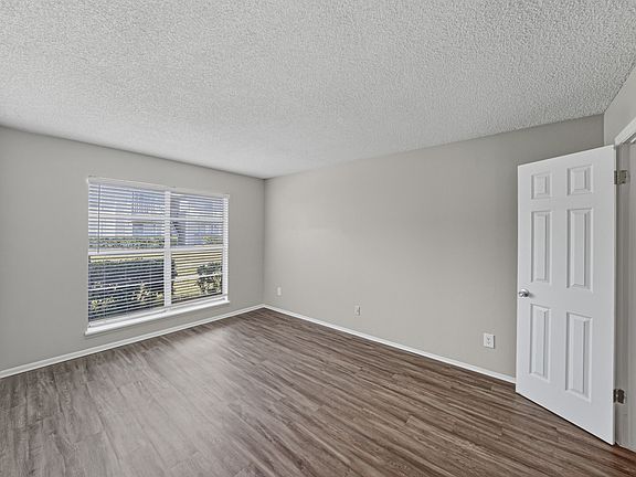 Bright guest bedroom in the two-bedroom apartment with updated flooring