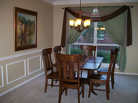 Open formal dinning room with accent chair rail molding