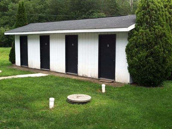 In the rear of the apartment building property is a walkway to the 10' X 10' individual storage units w/electric for each tenant