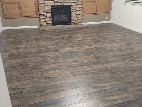 Spacious family room with lovely fireplace and built-ins on both sides for extra storage!