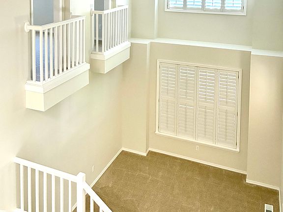 Step into luxury. Our soaring, open-concept living room captivates from the foyer and impresses from every balcony view. With dramatic high ceilings and an airy, light-filled layout, it's the perfect blend of grandeur and sophisticated comfort.