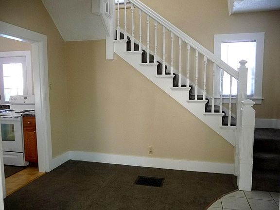 Front foyer/entry with kitchen off the foyer and stairs to second floor bedrooms & full bath