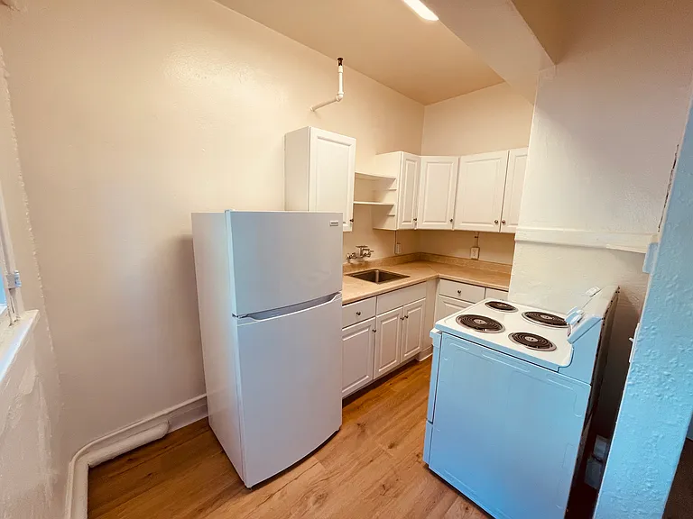 Kitchen with new appliances, new paint and lighting, newer cabinets