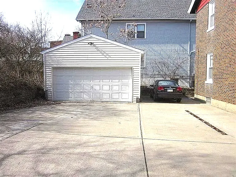 Large parking area and garage at the rear of the property.