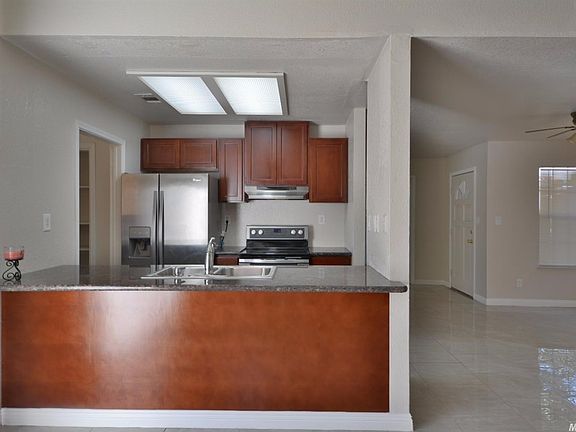 Dining bar with granite counters and updated kitchen cabinets.