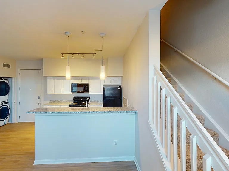Modern Kitchen and Stylish Staircase at Ralston Apartments in Downtown Indianapolis