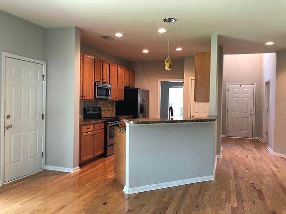 Kitchen with a breakfast bar that over look to the living room.
