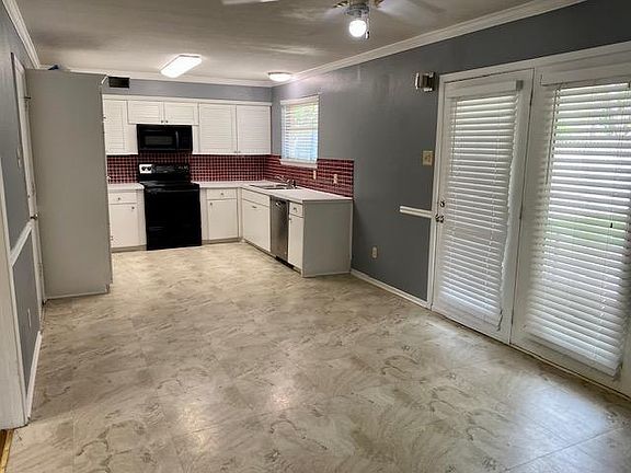 Large open concept kitchen with room for eating area and small living room or office space