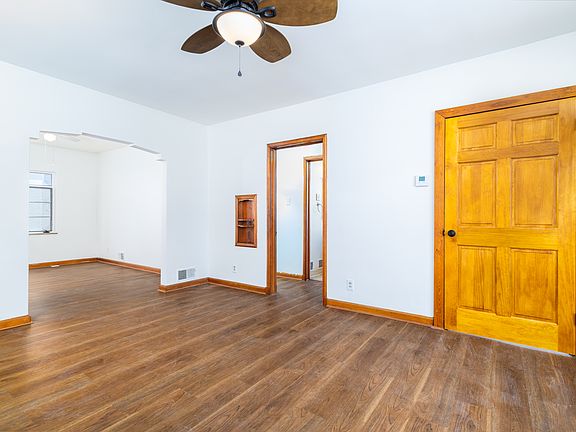 Living room looking at doorways to large bedroom, bathroom, and small bedroom / office