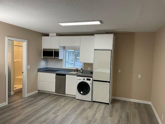 Brand new kitchen, contains new cabinets, granite counter, stove top, microwave/convection oven, dishwasher, washing machine/dryer combo, and fridge/freezer.