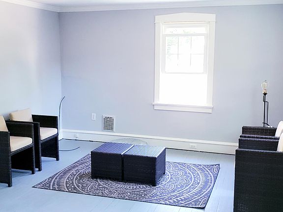 Living room features ceiling fan and crown molding detail. Painted hardwood floors throughout.