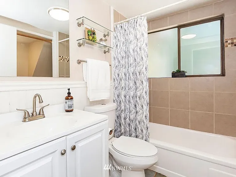 First Floor Bathroom and Laundry Area (Photo from Previous Listing)