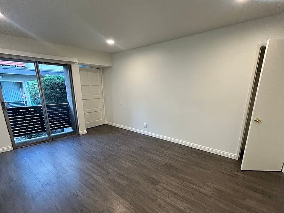 Living room with walk out balcony to courtyard