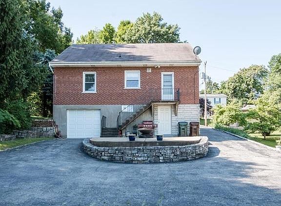 BACK OF HOME WITH PATIO AND LOTS OF ROOM FAR PARKING.