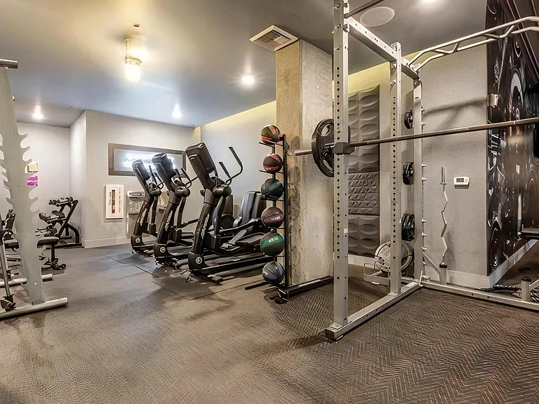 Apartment Gym Featuring Treadmills, Strength Equipment, and Free Weights