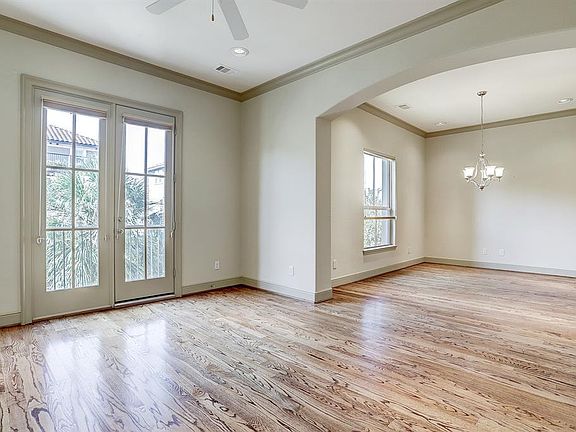 INSIDE THE 2ND LEVEL, YOU ARE GREETED WITH THE FORMAL LIVING AND DINING ROOMS WITH SOLID WOOD FLOORS AND CROWN MOLDING.