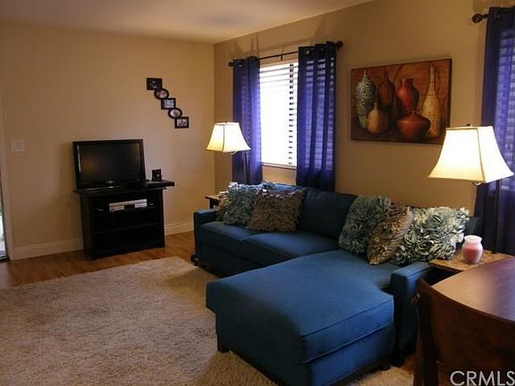 Beautiful living room with smooth ceilings, lots of sunlight, new floors, high baseboards, and neutral paint colors.