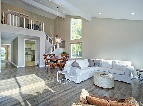 Open dining room steps down to living room. Wood laminate floors throughout