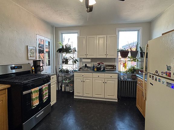 Large bright kitchen with new gas range.