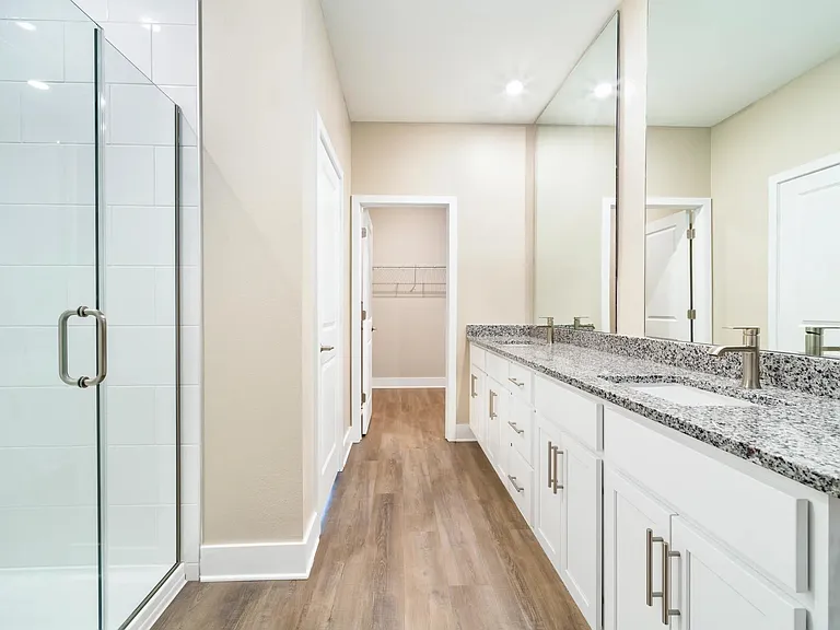 A spacious primary bath at Amavi Kissimmee offers dual vanities with generous storage and thoughtful design.