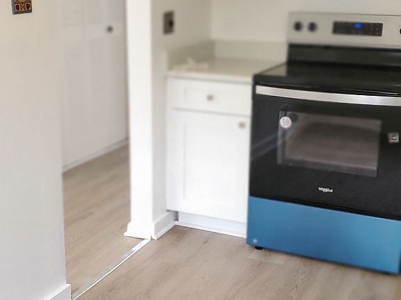 Large double hall closet outside of kitchen