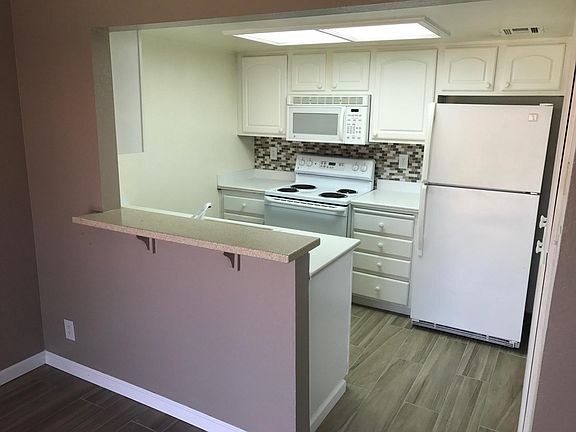 Entire kitchen photo. walls are a tan but not pink!