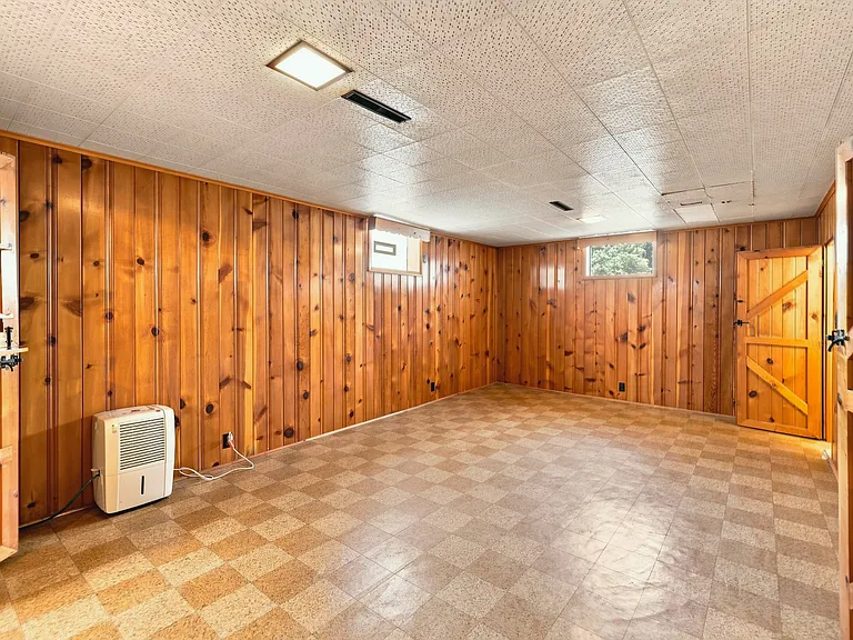 View walking down into the basement garden level. Lots of windows to let in natural light. Does not smell like a basement or flood. Great clean functional space.
