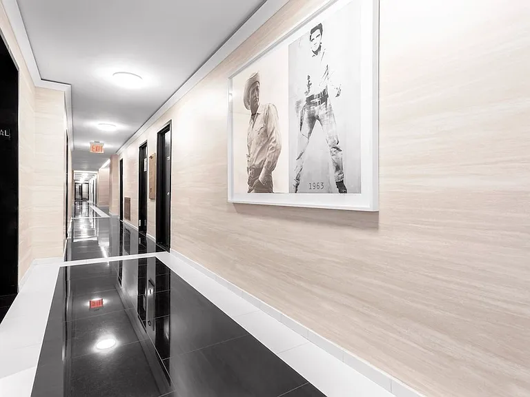 Step into elegance at The Century. This beautifully designed hallway features sleek finishes and stunning artwork, creating an inviting atmosphere. Embrace modern living with style and convenience. Schedule a tour today!