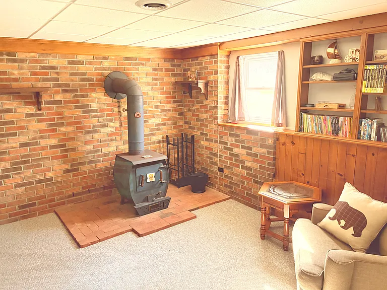 A charming wood_burning fireplace anchors the space, complemented by a small library and a cozy reading nook