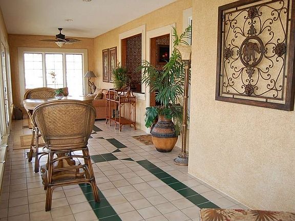 "Positioned to look out to the golf course, the sunroom is filled with light"