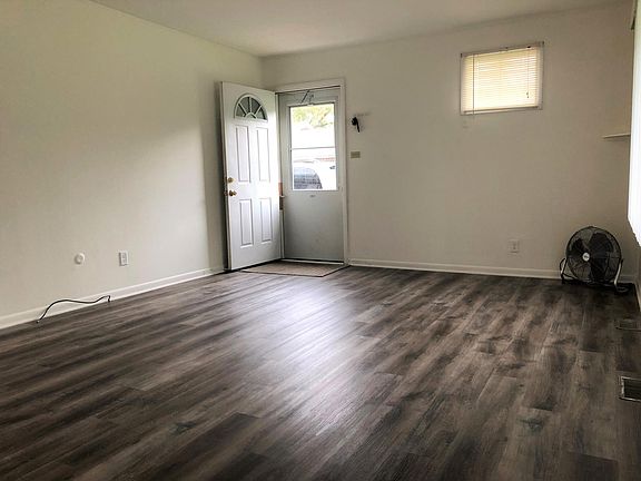 Front door opens to new floors in living room.