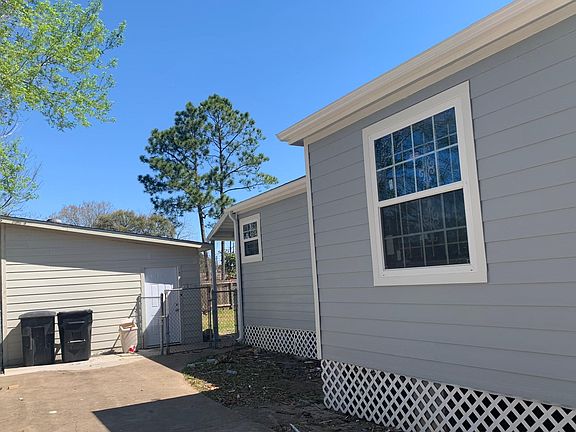 Driveway side. Large storage in back. Fence.