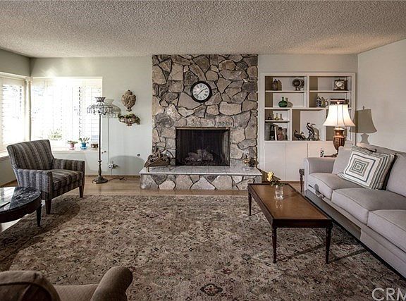 Spacious Living room with wood burning fireplace.
