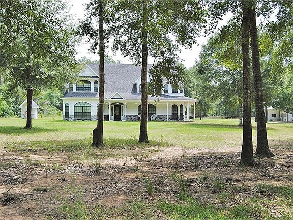 WELCOME TO 30940 COLLIER SMITH ROAD NESTLED ON 4.21 ACRES IN MAGNOLIA, TEXAS 77354HORSES WELCOME
