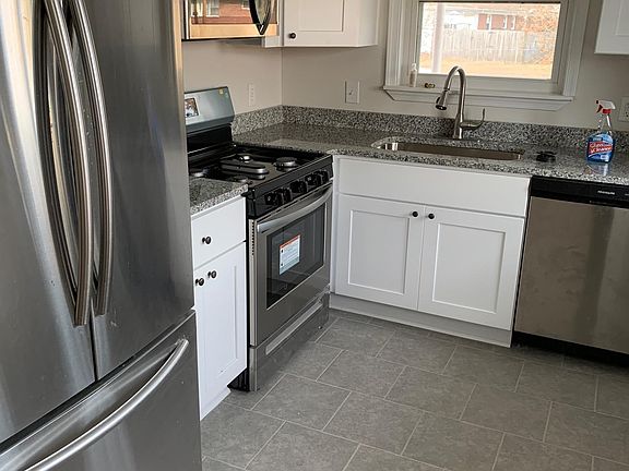 Beautifully redone kitchen with refrigerator, brand new gas range, microwave and dishwasher