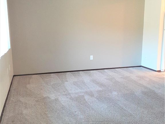 Spacious Living Area with neutral Accent Wall