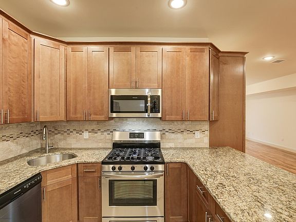 Pecan finished cabinetry with stainless steel appliances!