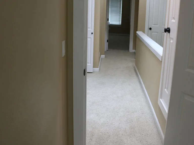 Upstairs hallway between the 3 bedrooms. Washer and Dryer on the left side of the hallway.