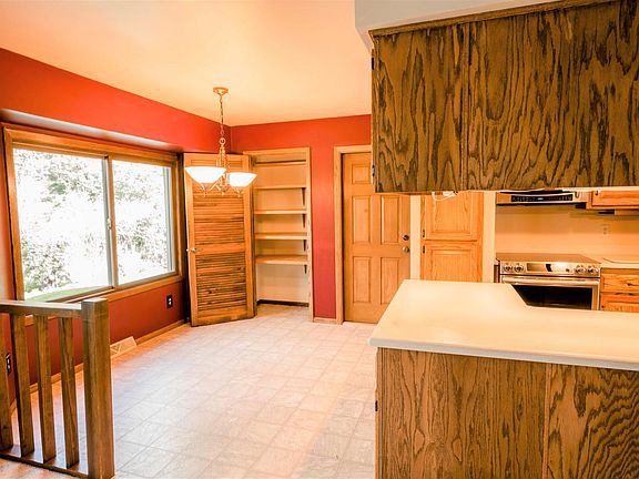 Spacious dinette/kitchen area with pantry cabinet and new appliances.