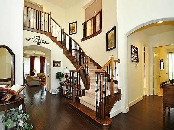 Hand scraped hardwood floors, beautiful tile in the wet areas, iron spindles on the staircase ... Open floor plan with private in-law quarters down stairs and away from the rest of the home.